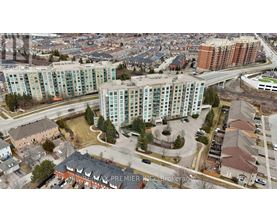 An aerial view of a city with apartment buildings and roads.
