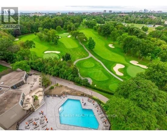 A golf course with a pool and a building in the foreground.