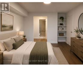 A bedroom with a bed, nightstand, and a painting on the wall.