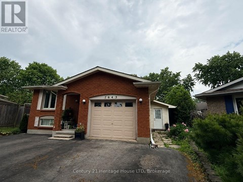 A house with a garage door that says 7643 on it.
