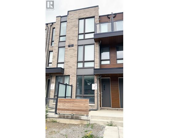 A modern apartment building with a wooden front door and glass windows.