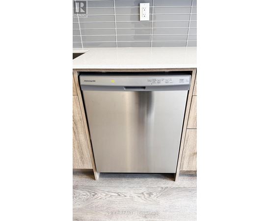A stainless steel dishwasher is placed in a kitchen.