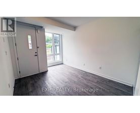 A room with a sliding glass door and a wooden floor.