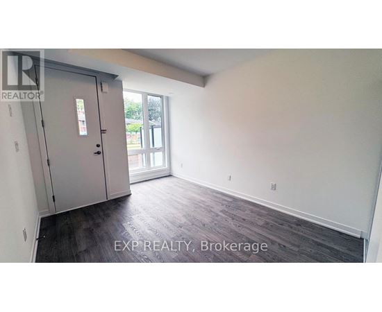 A room with a sliding glass door and a wooden floor.