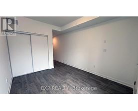 A room with a sliding door and wood flooring.