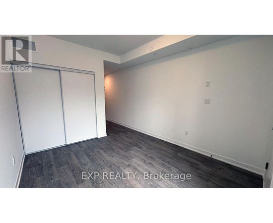 A room with a sliding door and wood flooring.