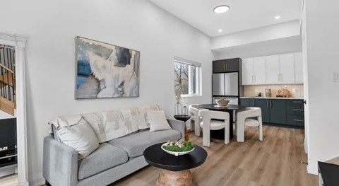 A modern living room with a grey sofa and a coffee table.