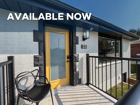 A house with a yellow door and a sign that says "AVAILABLE NOW".