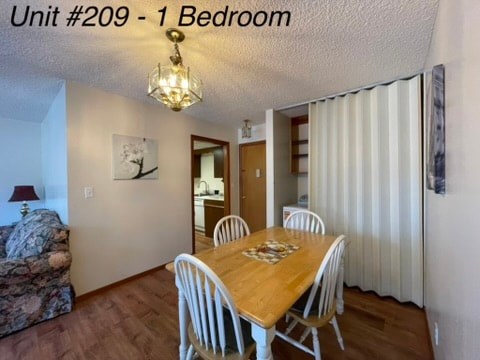 A dining room with a wooden table and chairs.