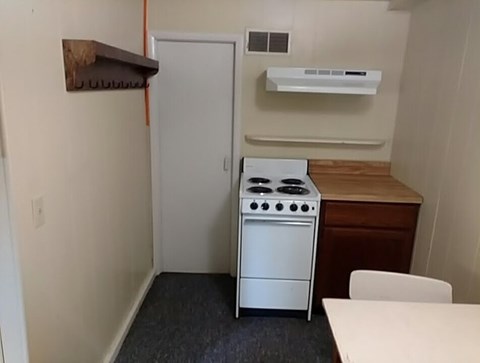 A small kitchen with a stove and a table.