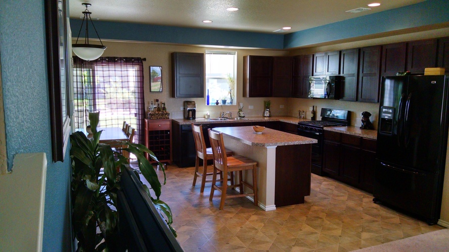 A kitchen with a tile floor and a counter.