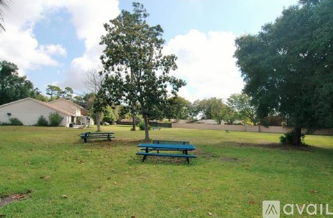 A park with a bench and trees.