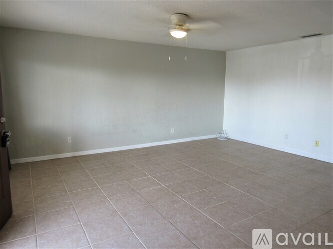 A room with beige tiled flooring and white walls.