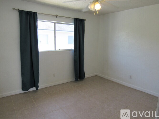 A room with a window and a fan.