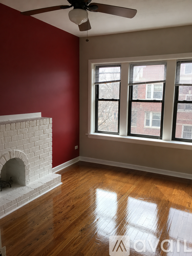 A room with a fireplace and a window.