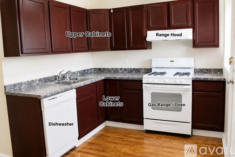 A kitchen with brown cabinets and a white dishwasher and oven.
