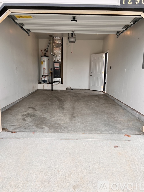 A garage with a white door and a wall with a number 1239 on it.