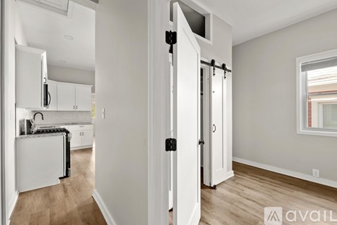 A kitchen with white appliances and cabinets is shown.
