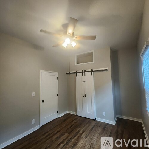 A room with a ceiling fan and a window.