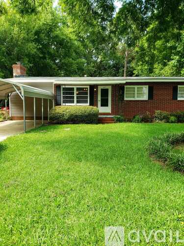 A house with a red brick exterior and a white door.