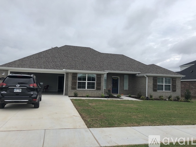 A house with a car parked in front.