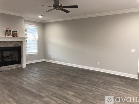 A room with a fireplace and a ceiling fan.