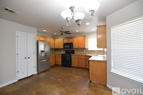 A kitchen with wooden cabinets and a black oven.
