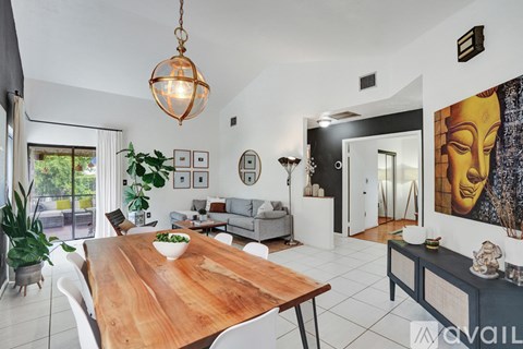A modern dining room with a wooden table and chairs.