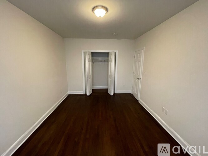 A room with wooden floors and white walls.