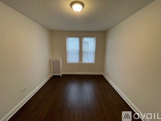 A room with a window and a radiator on the wall.