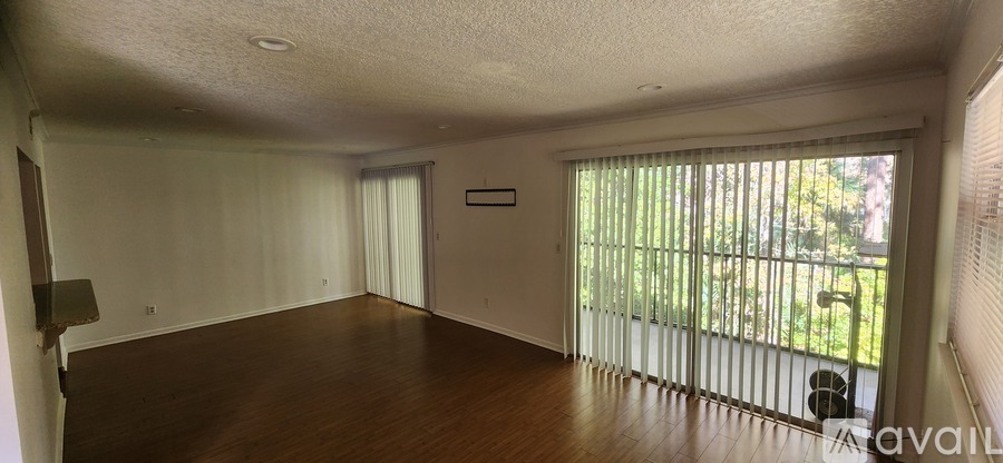 A room with a sliding glass door leading to a backyard.