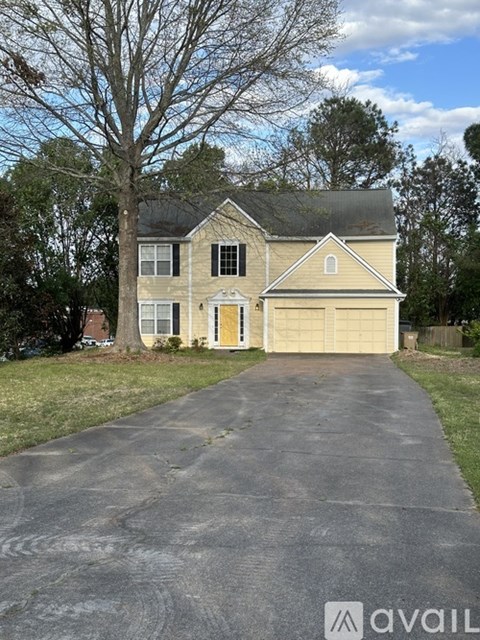 A house with a driveway in front of it.