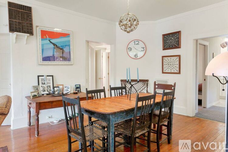 A dining room with a wooden table and chairs.