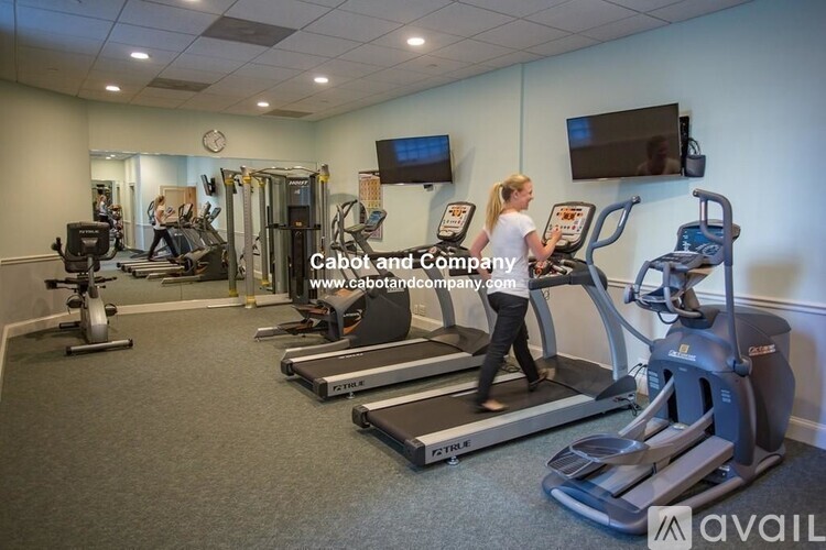 A woman is working out on a treadmill in a gym.