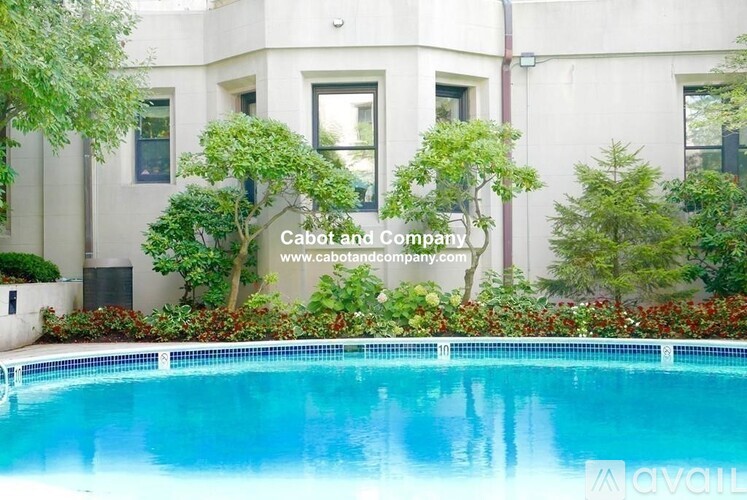 A pool in front of a building with the text "Cabot and Company" and a website address.