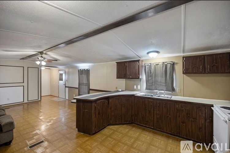 A kitchen with wooden cabinets and a white dishwasher.
