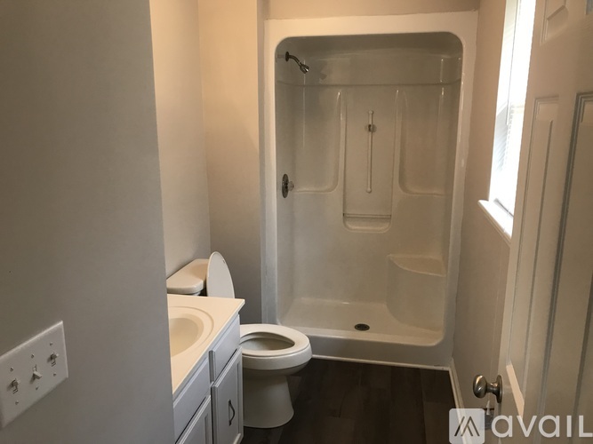 A bathroom with a toilet, sink, and bathtub.
