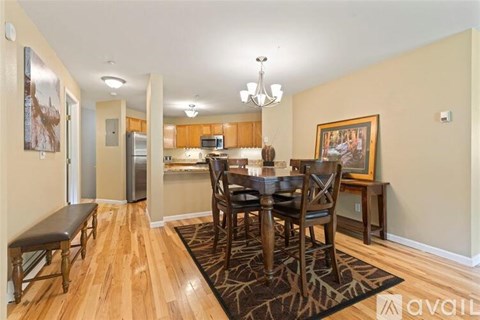 A dining room with a wooden table and chairs.
