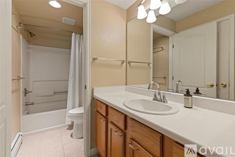 A bathroom with a white sink and a white toilet.