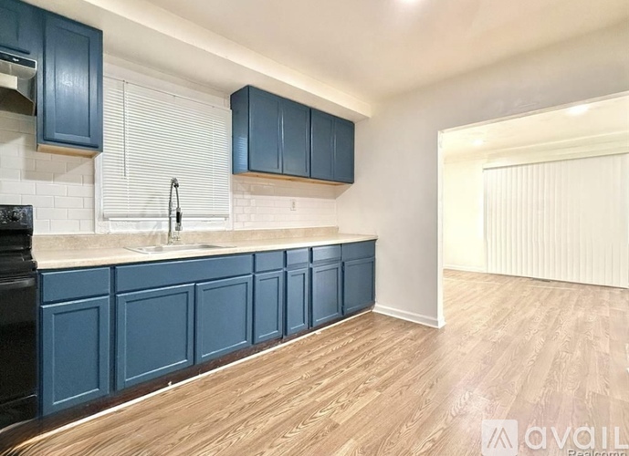 A kitchen with blue cabinets and a white sink.