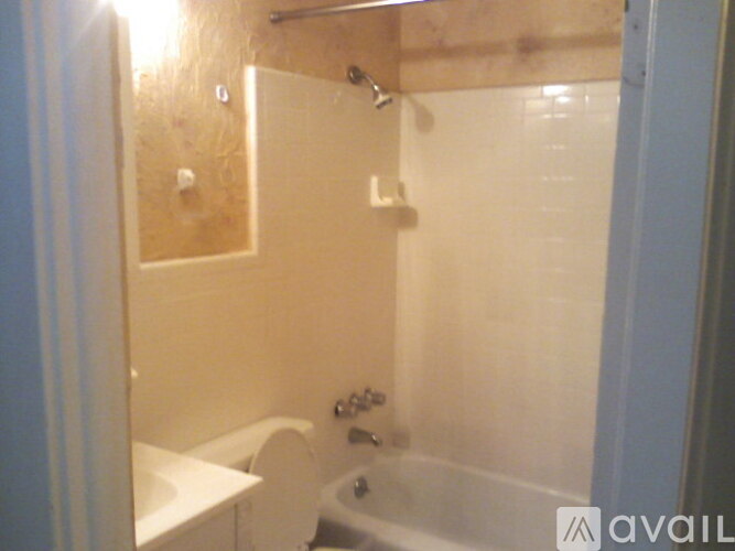 A bathroom with a toilet, sink, and bathtub.