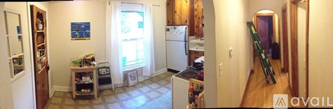 A kitchen with a refrigerator and a window.