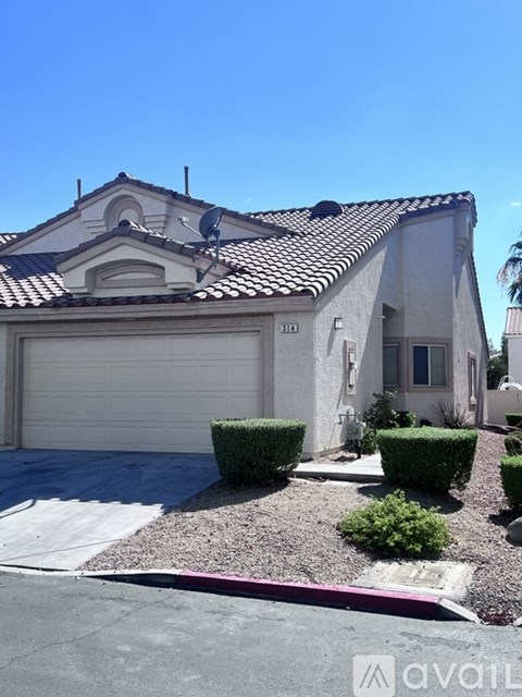 A house with a garage door and a driveway.