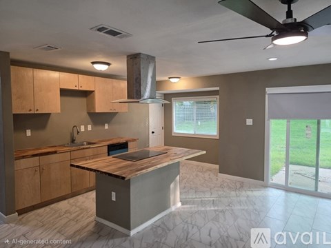 A kitchen with a wooden island and a ceiling fan.