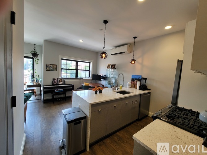 A kitchen with a white countertop and a black stove top oven.