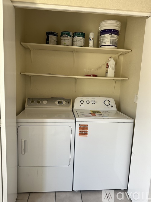 A small laundry room with a washer and dryer.