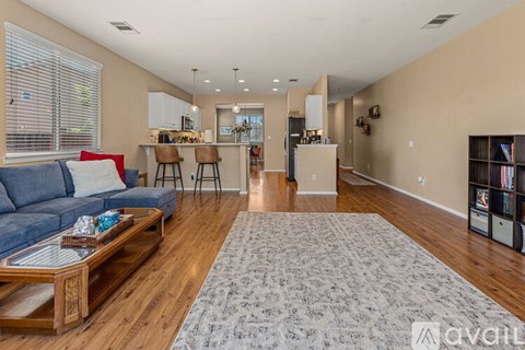 A living room with a blue couch and a coffee table in the center.