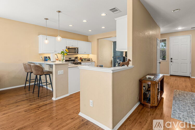 A kitchen with a white counter and a white fridge.