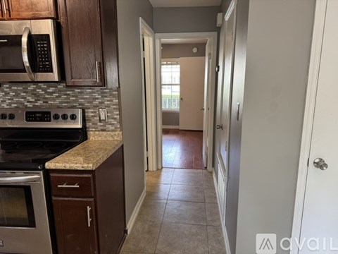 A kitchen with a stove top oven and microwave above a counter.