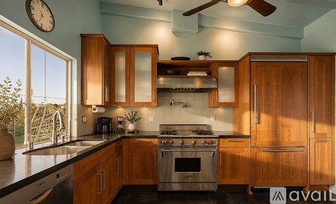 A kitchen with wooden cabinets and a stainless steel oven.